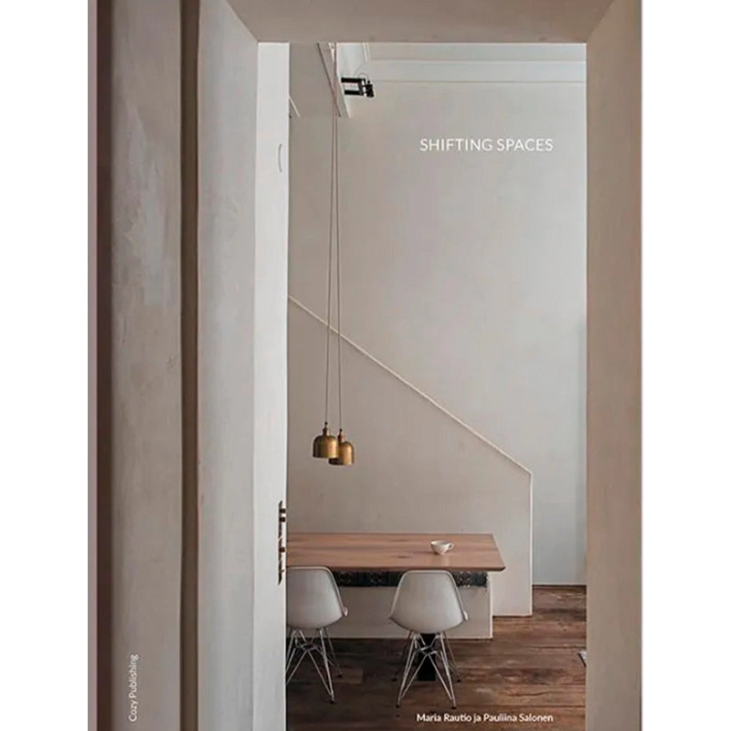 Portada del libro Shifting Spaces frente a un comedor con mesa y lámparas colgantes.
